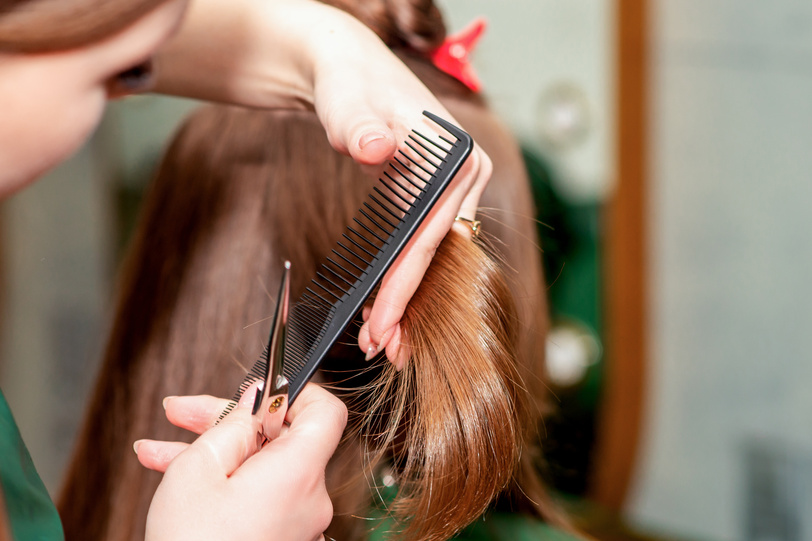 Woman receiving haircut.